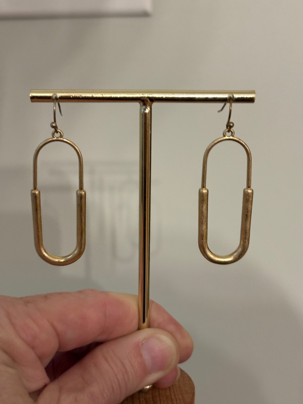Elongated gold-tone open-oval or pill-shaped drop earrings